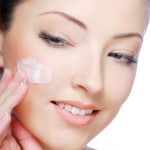 woman moisturizing her face